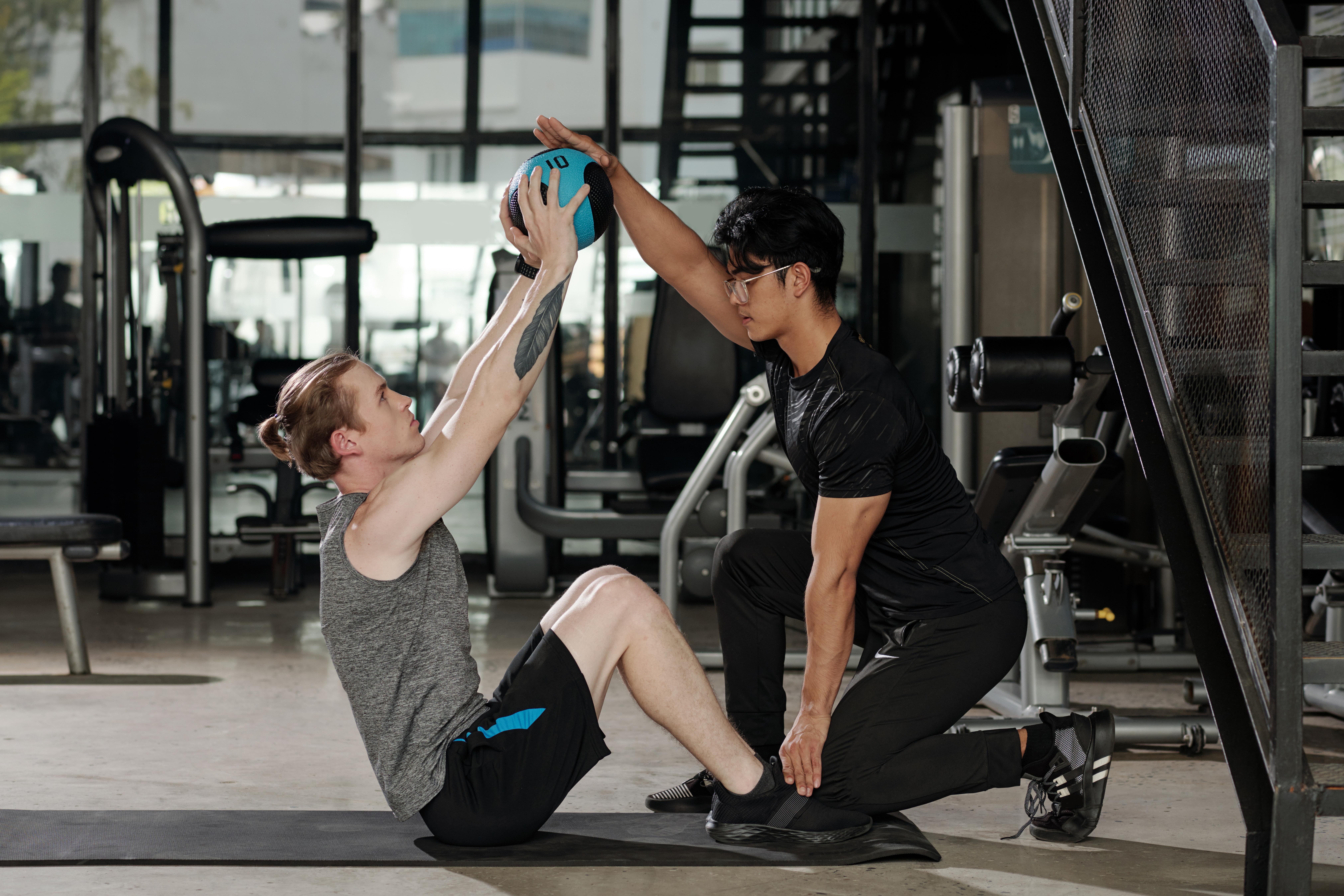 A Personal Trainer Working With A Client